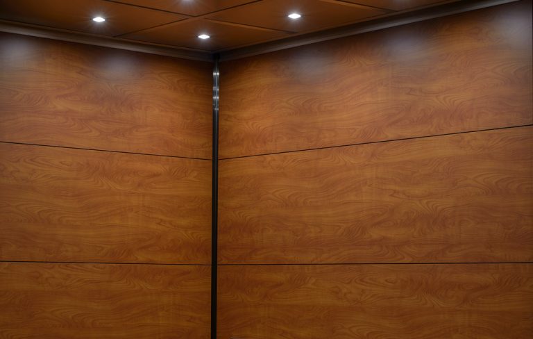 SnapCab Express elevator interior with modern laminate finish in a multi-cab residential building